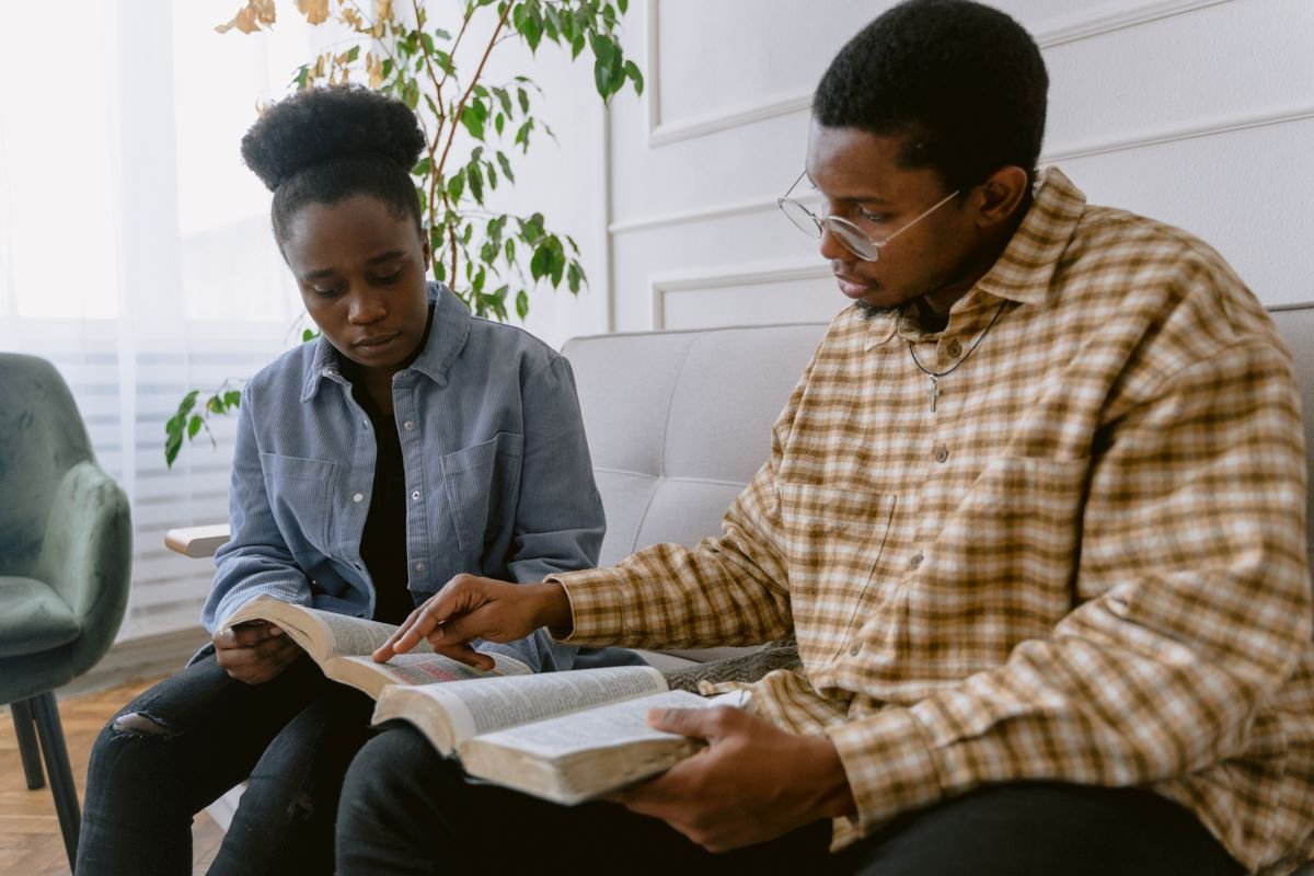 Two young adults studying the Bible together